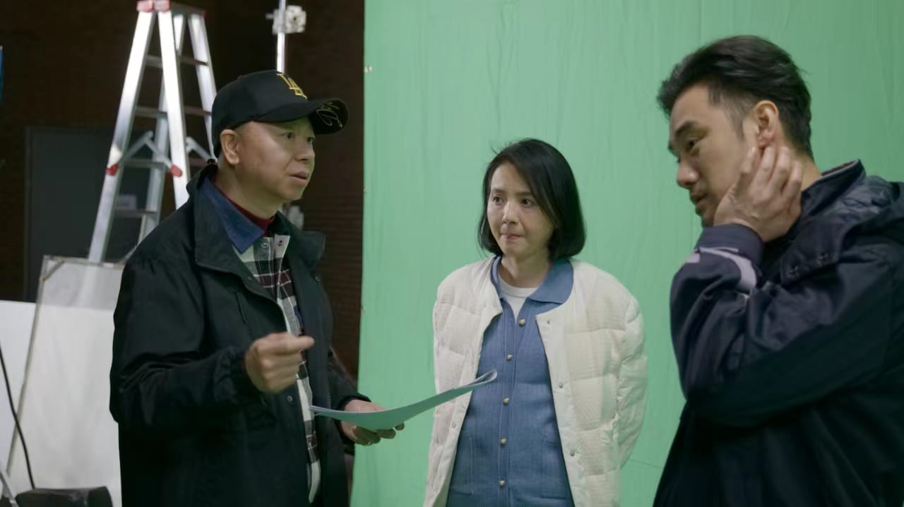 Three people in a green-screen production setting